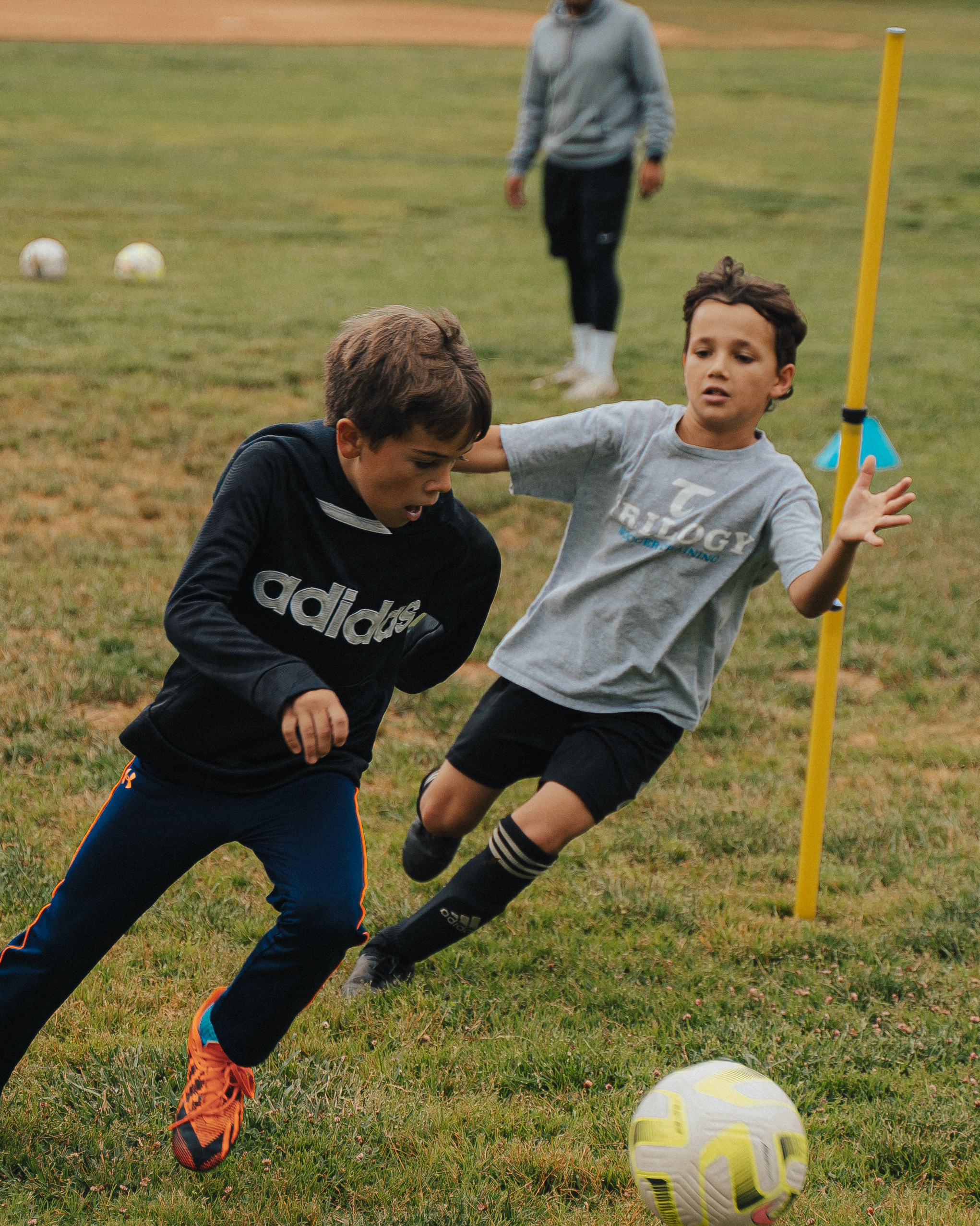 Trilogy soccer players in a dribbling drill