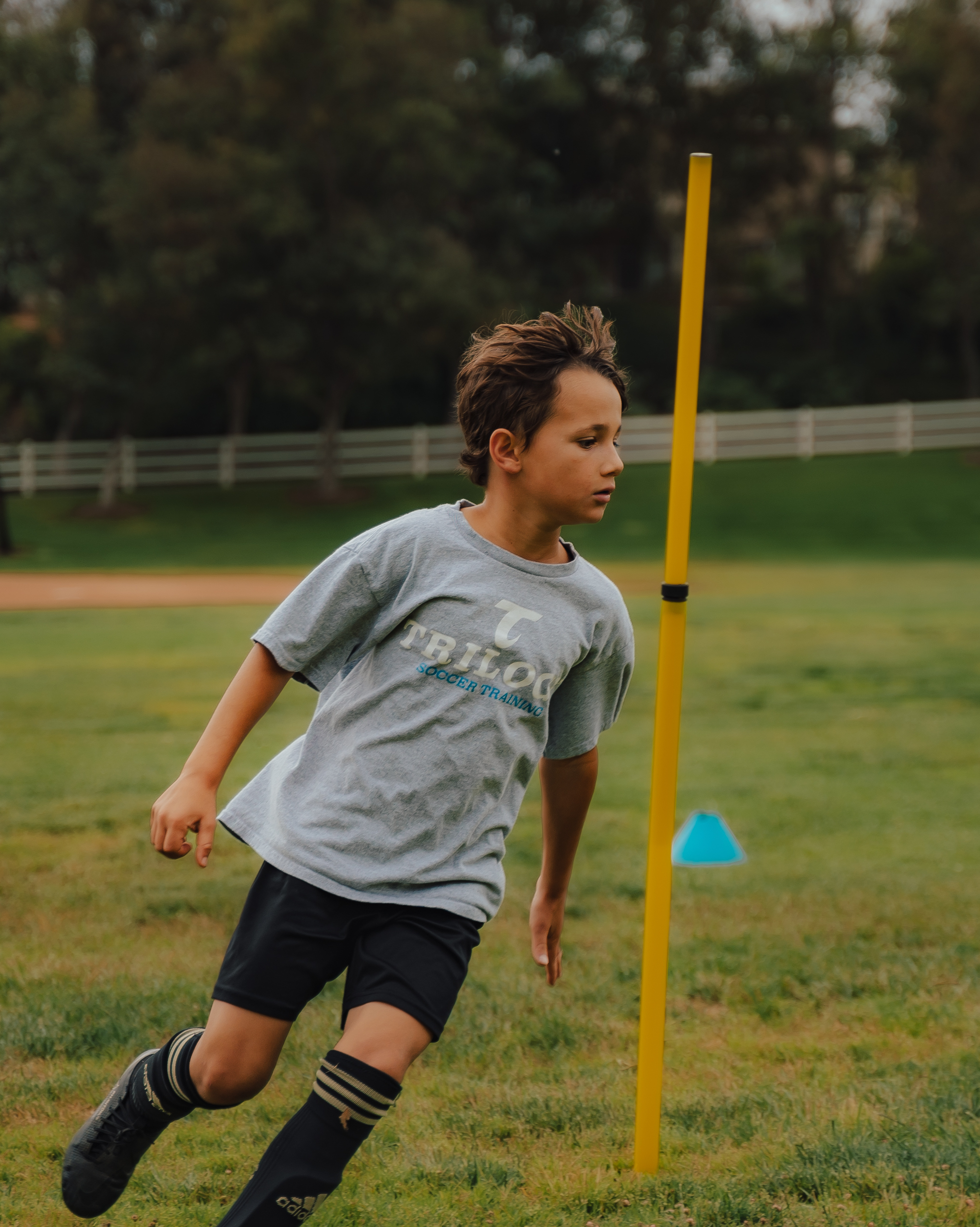 Cole running around a yellow pole