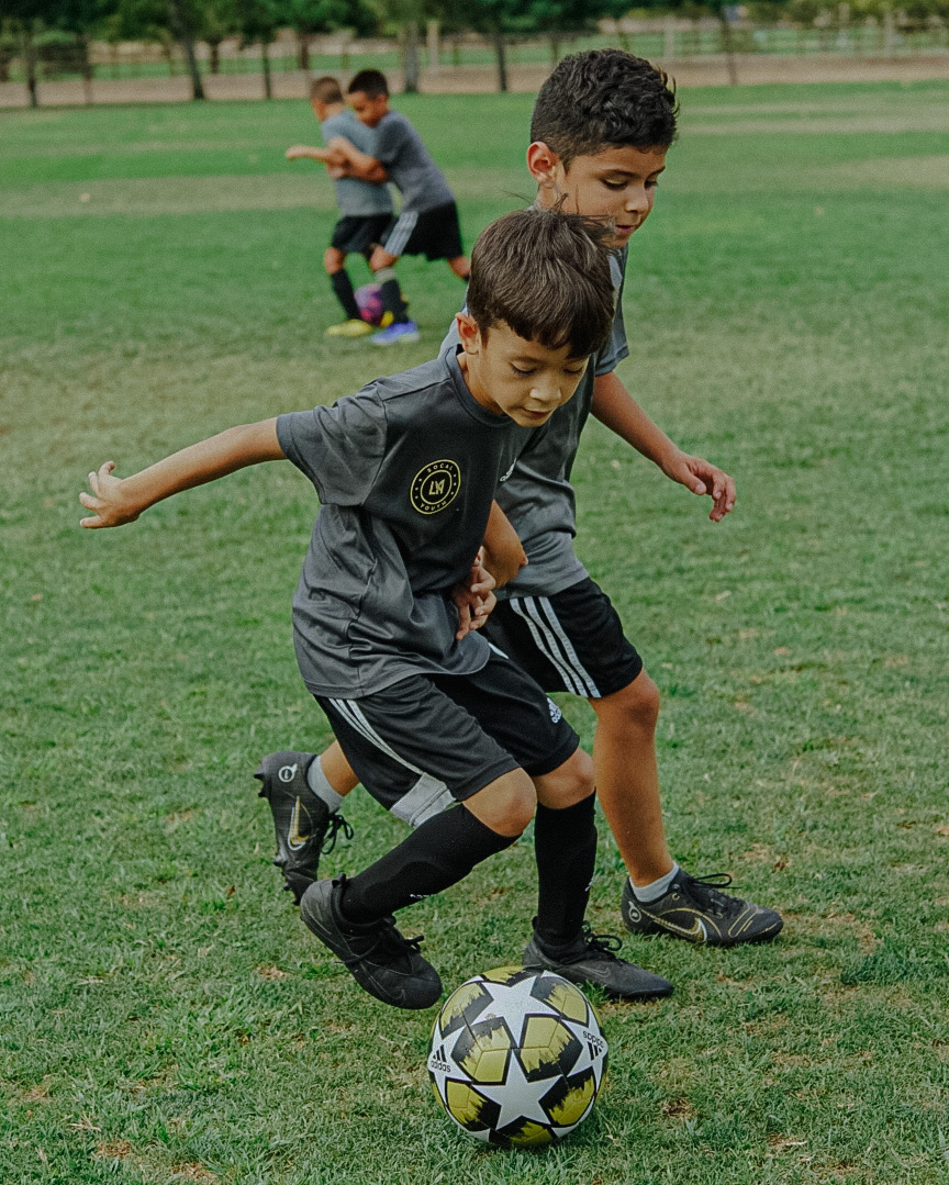 Alonso and Nathan dribbling and shielding the soccer ball